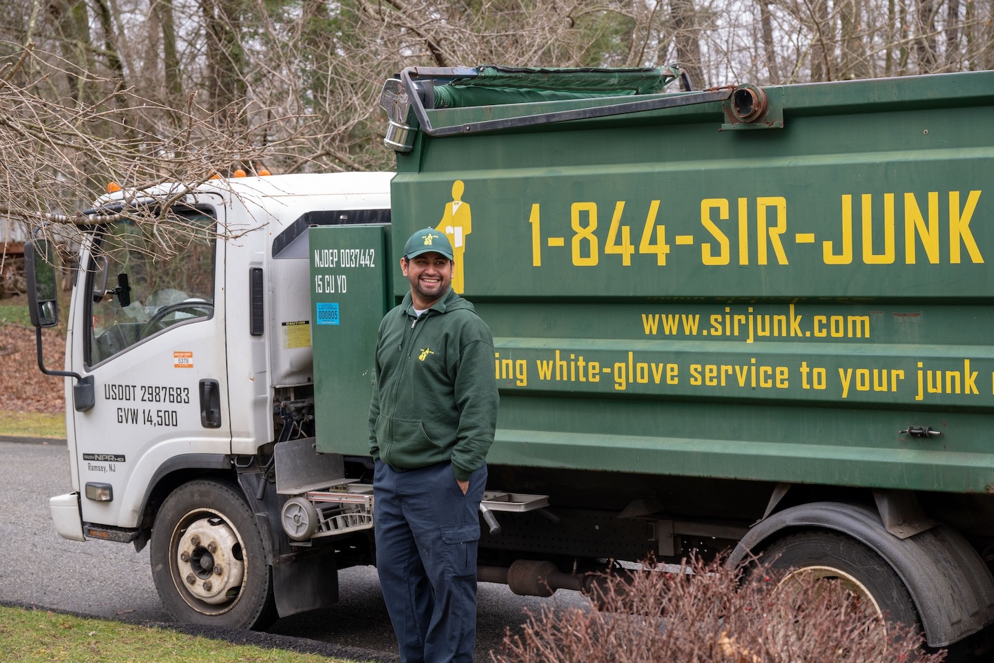 SIR JUNK employee standing by the truck